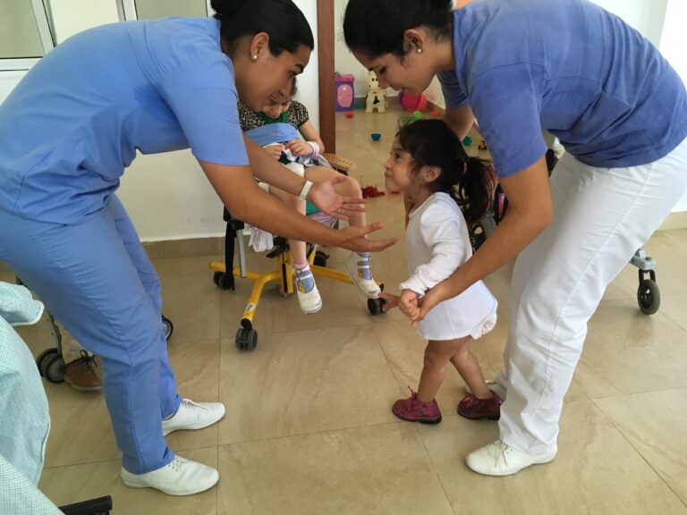 The nurses teaching Xochiti to walk